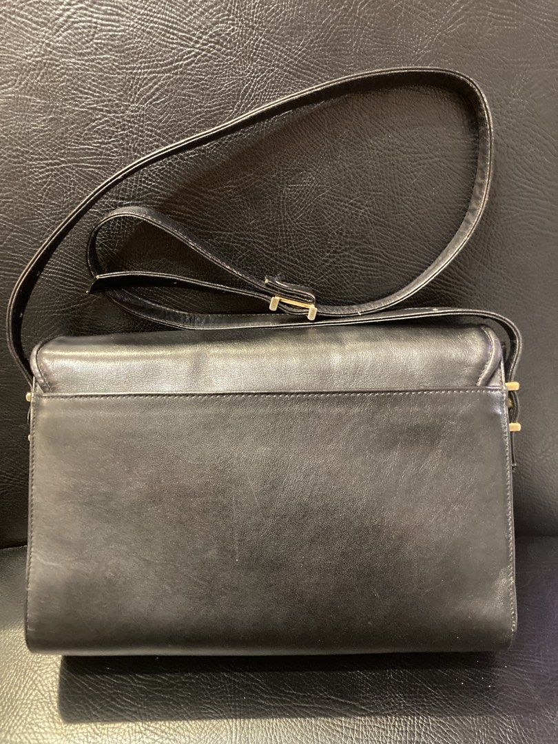 Givenchy Black Leather Shoulder Bag with Gold Clasp (Category: Luxury Bags & Wallets) located in Quezon City. Submitted by janisu0303 (Listing ID 1461050221, Image 2). Description: GIVENCHY Vintage Shoulder Bag. 8500 php Authentic Fairview area meetups Or shipping This chic handbag is crafted from black leather with a snakeskin-effect texture, including a length-adjustable matching strap. It features a gold-tone steel magnetic closure and four in