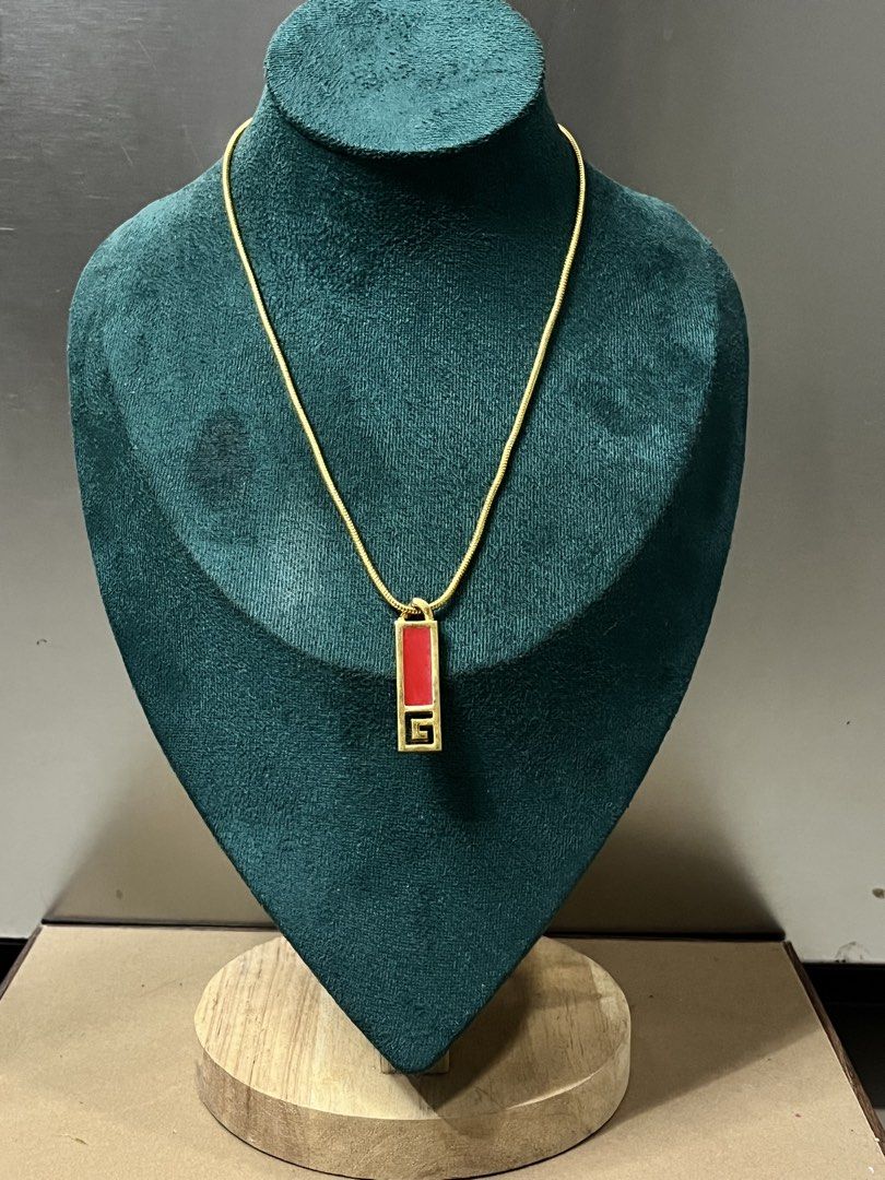 Givenchy Gold Necklace with Red Pendant (Category: Necklaces) located in Bulacan. Submitted by vintagetreasureby.mivida (Listing ID 1460956462, Image 1). Description: - Vintage Givenchy necklace - Gold chain - Rectangular red pendant - Iconic Givenchy logo on the back - Clasp closure - Approximately 18 inches in length - A classic addition to any jewelry collection.