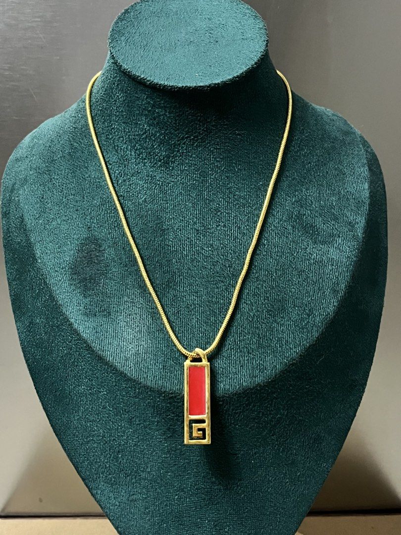 Givenchy Gold Necklace with Red Pendant (Category: Necklaces) located in Bulacan. Submitted by vintagetreasureby.mivida (Listing ID 1460956462, Image 2). Description: - Vintage Givenchy necklace - Gold chain - Rectangular red pendant - Iconic Givenchy logo on the back - Clasp closure - Approximately 18 inches in length - A classic addition to any jewelry collection.