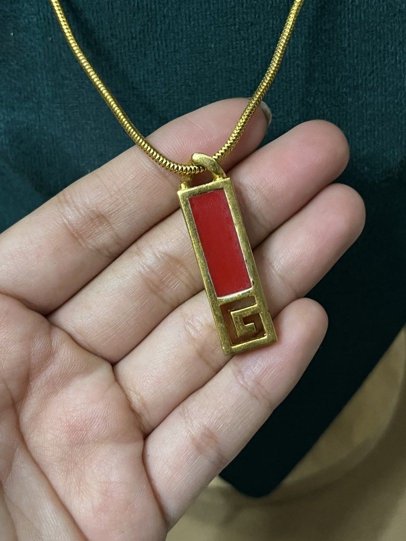 Givenchy Gold Necklace with Red Pendant (Category: Necklaces) located in Bulacan. Submitted by vintagetreasureby.mivida (Listing ID 1460956462, Image 3). Description: - Vintage Givenchy necklace - Gold chain - Rectangular red pendant - Iconic Givenchy logo on the back - Clasp closure - Approximately 18 inches in length - A classic addition to any jewelry collection.