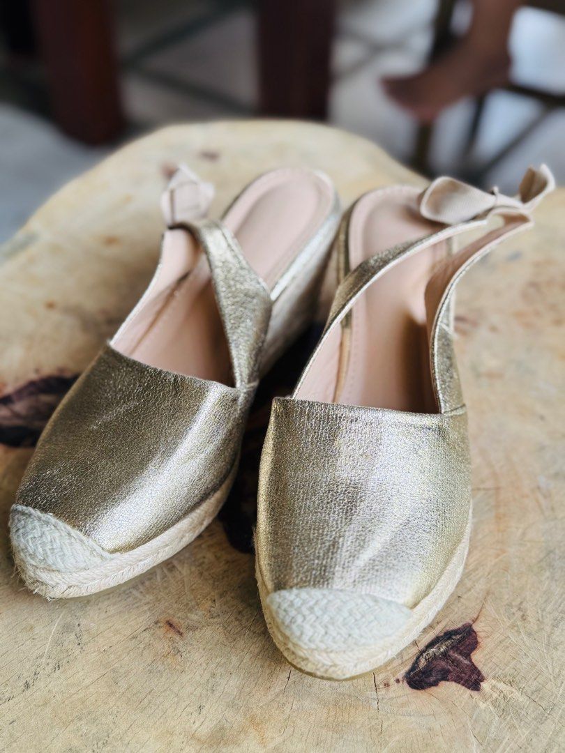 Gold Metallic Espadrille Wedge Slingback Heels (Category: Wedges) located in Bacolod City. Submitted by vintage_vogue6100 (Listing ID 1460980539, Image 3). Description: - Gold metallic espadrille wedge heels - Slingback style with tie-up ankle ribbons - Trendy square toe design - Comfortable wedge heel with natural jute detailing - Versatile: dress up or down - Ideal for summer occasions.