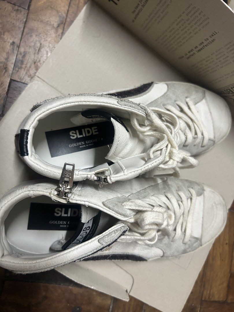 Golden Goose Slide Sneakers White Glitter Star (Category: Sneakers & Footwear) located in Quezon City. Submitted by apmso (Listing ID 1461069331, Image 2). Description: - Authentic Golden Goose white high-top sneakers - Signature star detail with glitter accents - Convenient side zip closure - Comes with original box - Includes original black laces - Made in Italy - Size 41 GUARANTEED AUTHENTIC RFS: downsizing shoe collection.