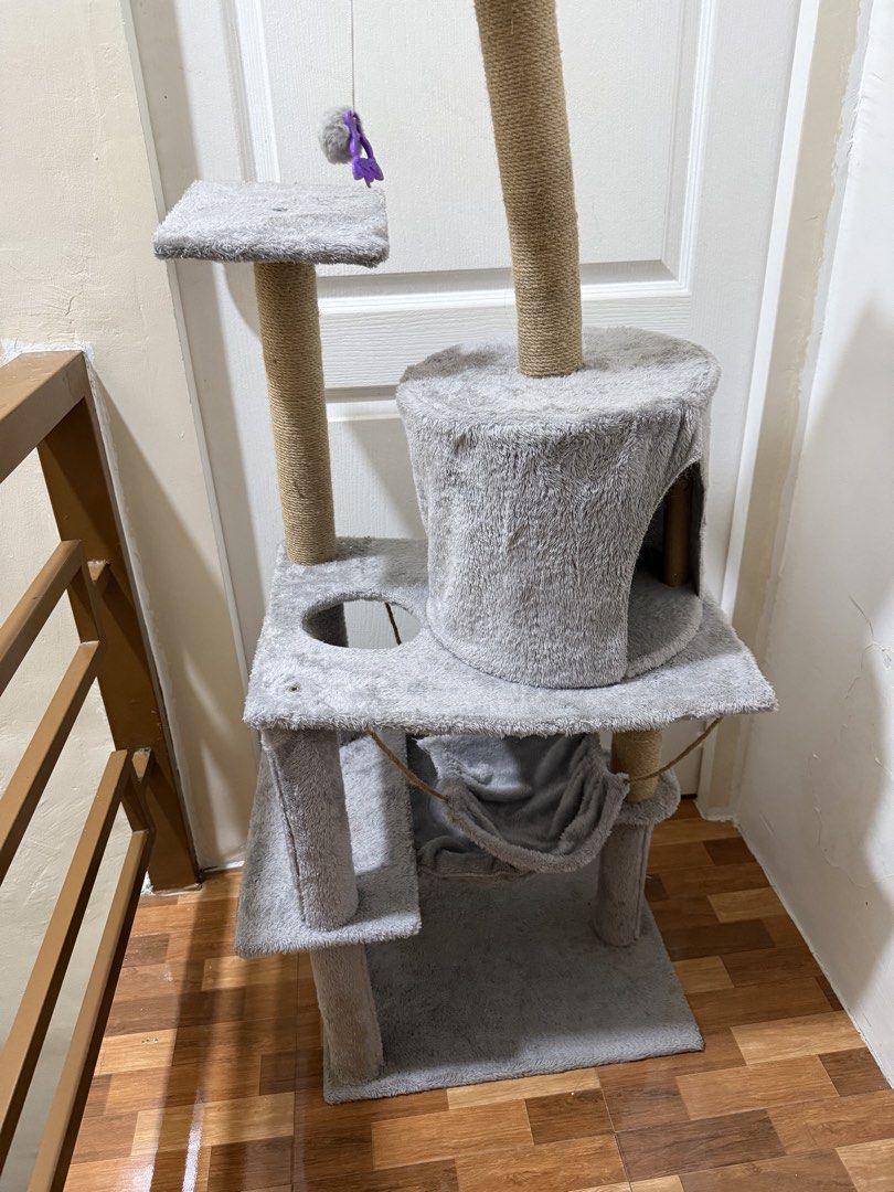 Grey Cat Tree Condo with Scratching Posts and Hammock (Category: Homes & Other Pet Accessories) located in Marikina City. Submitted by ms.ces (Listing ID 1460962025, Image 1). Description: - Multi-level grey cat tree condo - Multiple climbing and lounging levels - Sisal rope scratching posts - Relaxing hammock - Dangling toy for entertainment - Promotes activity and engagement - Easy assembly.