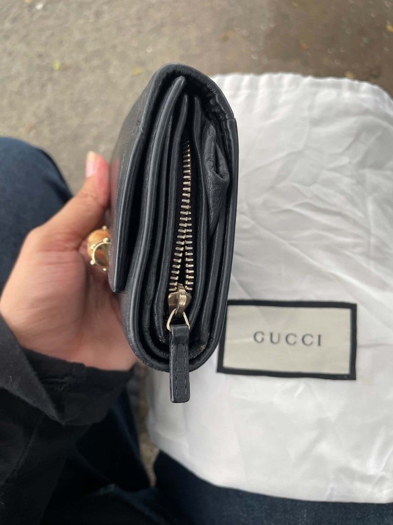 Gucci Bamboo Black Leather Wallet (Category: Luxury Bags & Wallets) located in Cainta. Submitted by mariss.luxx (Listing ID 1460993074, Image 3). Description: - Authentic Gucci wallet - Black pebbled leather with iconic bamboo accent - Multiple card slots and compartments - Zippered coin pocket - Fold-over closure with snap button - Comes with Gucci dust bag - Perfect for organizing essentials.