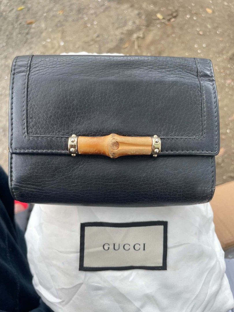 Gucci Bamboo Black Leather Wallet (Category: Luxury Bags & Wallets) located in Cainta. Submitted by mariss.luxx (Listing ID 1460993074, Image 1). Description: - Authentic Gucci wallet - Black pebbled leather with iconic bamboo accent - Multiple card slots and compartments - Zippered coin pocket - Fold-over closure with snap button - Comes with Gucci dust bag - Perfect for organizing essentials.