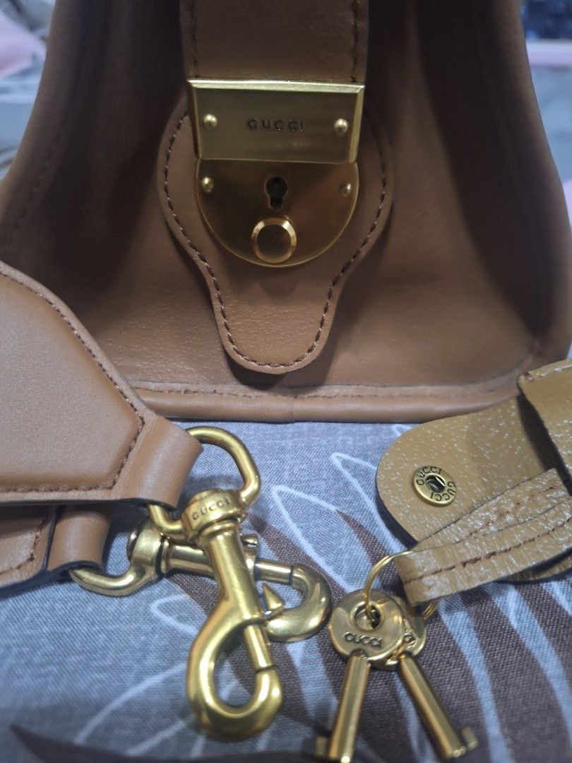 Gucci Bauletto (Category: Luxury Bags & Wallets) located in Makati City. Submitted by mccoooy (Listing ID 1461002460, Image 3). Description: - Authentic brown leather Gucci bag - Signature green and red stripe detail - Gold hardware - Detachable shoulder strap - Includes luggage tag and lock with keys - Interior zip pocket - Serial number visible inside.