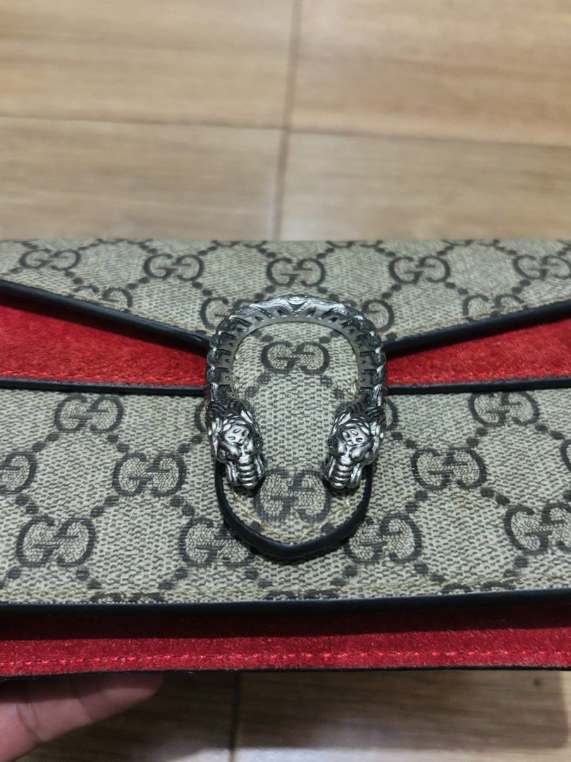 Gucci Dionysus GG Supreme Mini Bag (Category: Luxury Bags & Wallets) located in Aroroy. Submitted by paldogs (Listing ID 1461072224, Image 3). Description: - Authentic Gucci Dionysus mini bag - Signature GG Supreme canvas - Red suede detailing - Iconic tiger head closure - Versatile chain strap - Luxurious red leather interior.