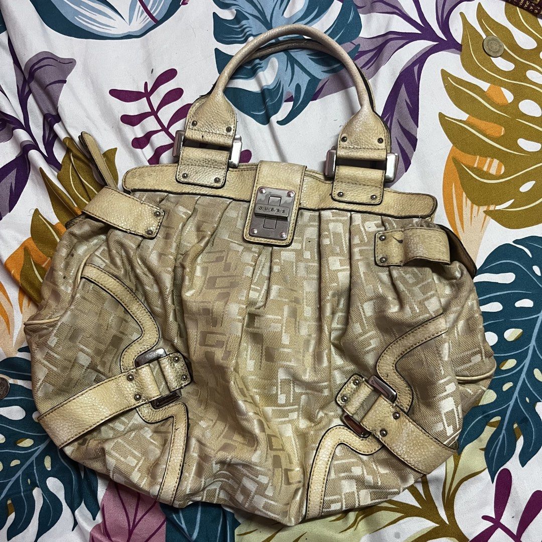 Guess Monogram Shoulder Bag (Category: Luxury Bags & Wallets) located in Caloocan City. Submitted by evermoonlit (Listing ID 1461035889, Image 1). Description: - Cream Guess shoulder bag - All-over monogram pattern - Leather trim and handles - Buckle closures on the front - Top zipper closure - Interior zippered pocket - Note: Some scuffs and marks on fabric, especially on the front.