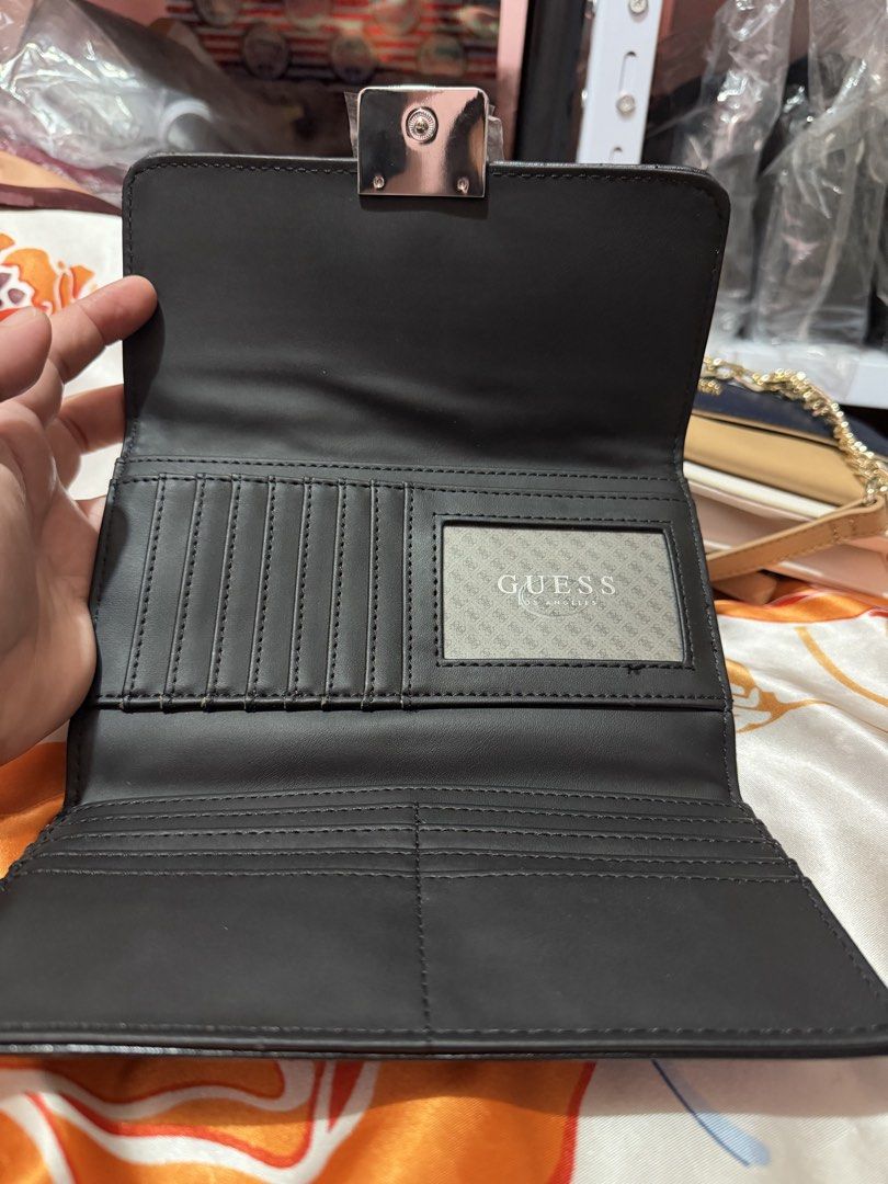 Guess Quilted Wallet Black (Category: Wallets & Card holders) located in La Trinidad. Submitted by ace32010 (Listing ID 1461072023, Image 3). Description: - Authentic Guess wallet - Stylish quilted design on front flap - Convenient zip pocket on the back - Multiple card slots and compartments inside for organization - Includes original tag with style number and price - Perfect for keeping your essentials tidy.