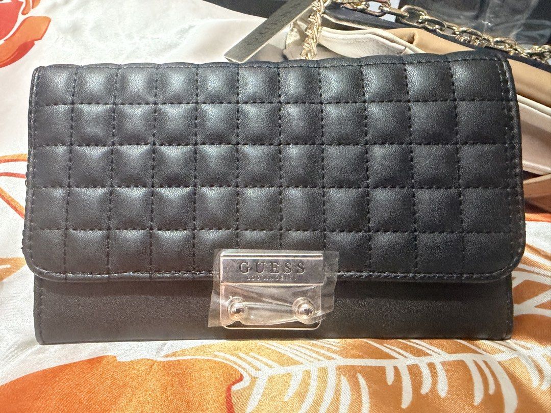 Guess Quilted Wallet Black (Category: Wallets & Card holders) located in La Trinidad. Submitted by ace32010 (Listing ID 1461072023, Image 1). Description: - Authentic Guess wallet - Stylish quilted design on front flap - Convenient zip pocket on the back - Multiple card slots and compartments inside for organization - Includes original tag with style number and price - Perfect for keeping your essentials tidy.