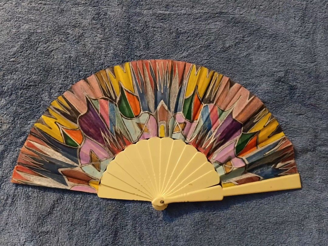 Hand-painted Folding Fan with Colorful Abstract Design from Spain (Category: Fans) located in Manila. Submitted by gt747express (Listing ID 1460947708, Image 1). Description: - Unique hand-painted folding fan - Vibrant, abstract multi-color design - Light cream colored frame - Signed 'Maria Fernandez' - Ideal for decoration or as a unique accessory - Folds neatly for portability size 9 x 17 .