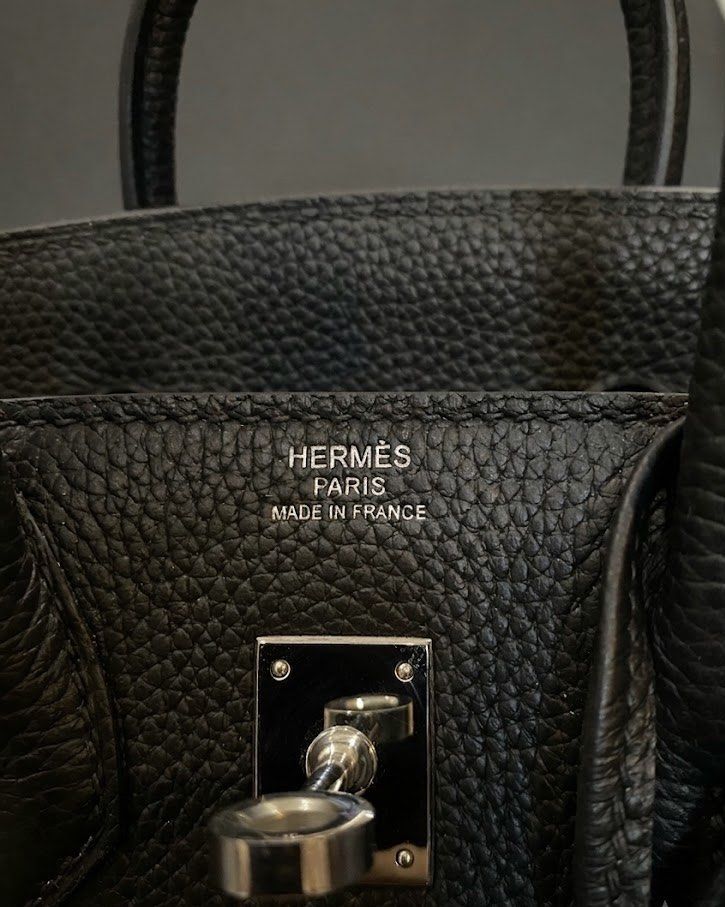 Hermes Birkin 25 Noir Black (Category: Luxury Bags & Wallets) located in Alfonso. Submitted by harper_preloved (Listing ID 1461037523, Image 3). Description: - Japan flea market finds - Togo leather - Serial number - With clochette, lock and keys - Comes with dust bags.