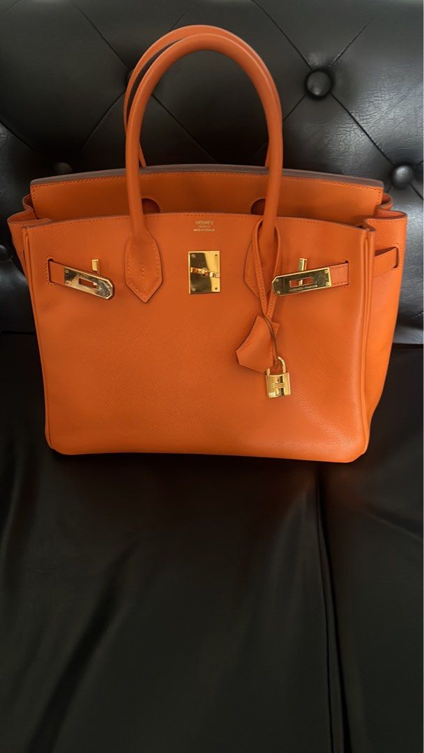 Hermes Birkin Orange Leather Gold Hardware B30 (Category: Luxury Bags & Wallets) located in Muntinlupa City. Submitted by john173 (Listing ID 1460945035, Image 1). Description: - Genuine orange leather handbag - Elegant gold hardware details - Includes original lock and keys - Comfortable top handles for carrying - Timeless structured design - Versatile for daily use or special events Stamp M, complete with dustbag, raincoat Guaranteed authentic.