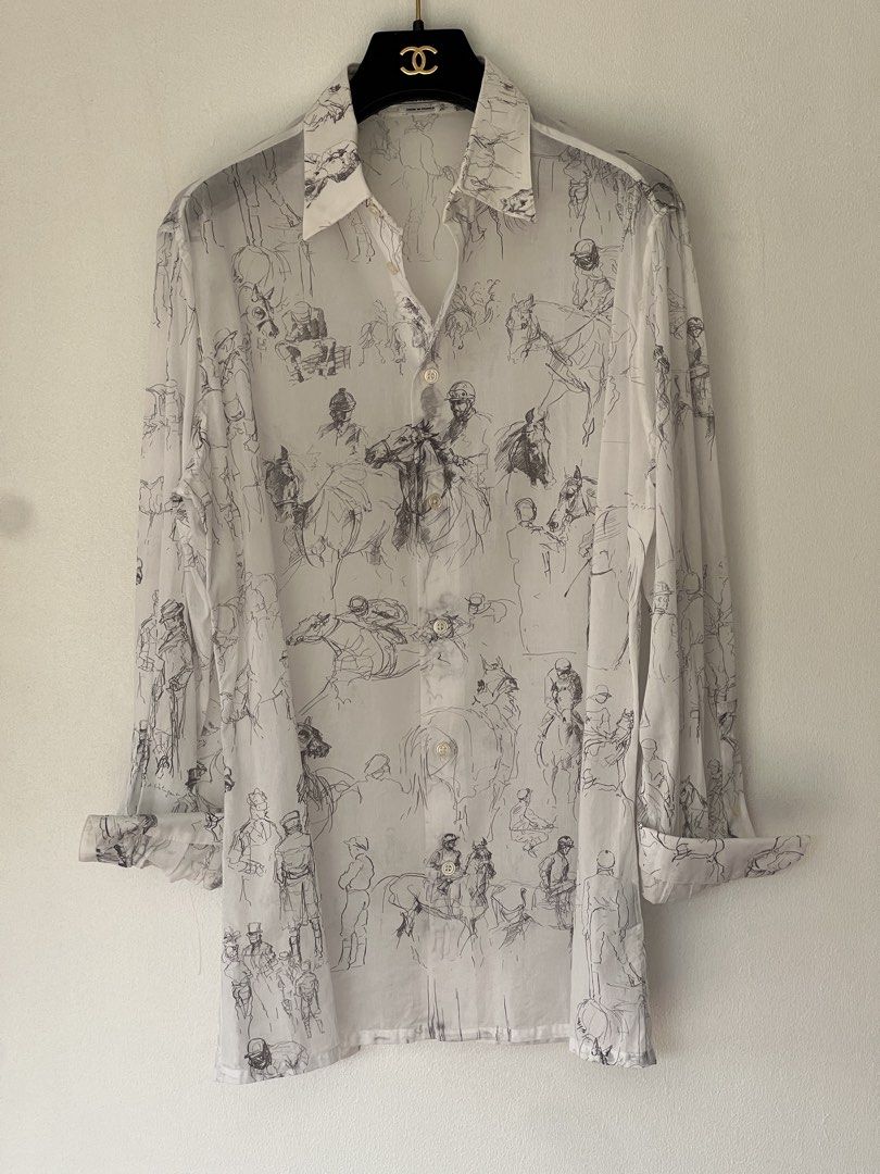 Hermes cotton voile shirt (Category: Luxury Apparel) located in Quezon City. Submitted by raccoonfur (Listing ID 1460959217, Image 3). Description: Equestrian-scribbled white cotton shirt by Hermes. Breathable semi-sheer voile fabric. Interesting silver double cuff buttons that just elevate the whole garment. Great condition. Flat measurements: Armpit to armpit 54cm Waist 48.25cm Length 74.25cm Shoulders 46cm Sleeve length when cuffed 60cm.