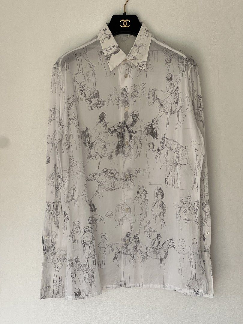 Hermes cotton voile shirt (Category: Luxury Apparel) located in Quezon City. Submitted by raccoonfur (Listing ID 1460959217, Image 2). Description: Equestrian-scribbled white cotton shirt by Hermes. Breathable semi-sheer voile fabric. Interesting silver double cuff buttons that just elevate the whole garment. Great condition. Flat measurements: Armpit to armpit 54cm Waist 48.25cm Length 74.25cm Shoulders 46cm Sleeve length when cuffed 60cm.