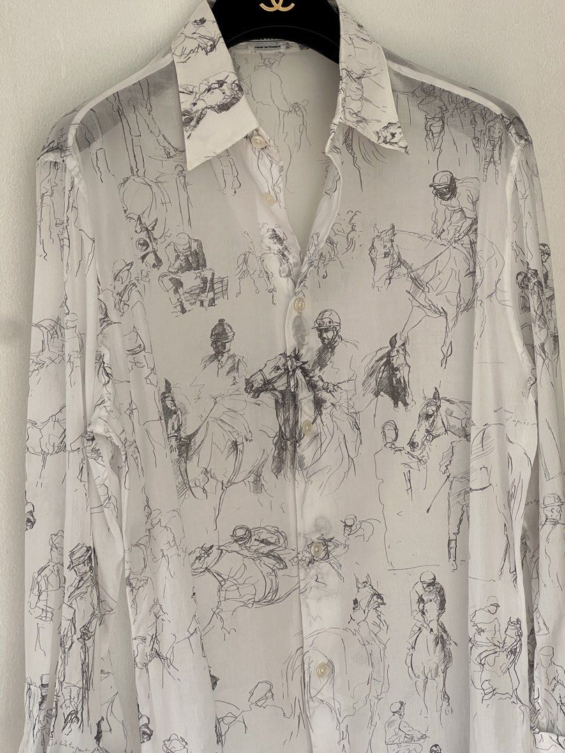 Hermes cotton voile shirt (Category: Luxury Apparel) located in Quezon City. Submitted by raccoonfur (Listing ID 1460959217, Image 1). Description: Equestrian-scribbled white cotton shirt by Hermes. Breathable semi-sheer voile fabric. Interesting silver double cuff buttons that just elevate the whole garment. Great condition. Flat measurements: Armpit to armpit 54cm Waist 48.25cm Length 74.25cm Shoulders 46cm Sleeve length when cuffed 60cm.