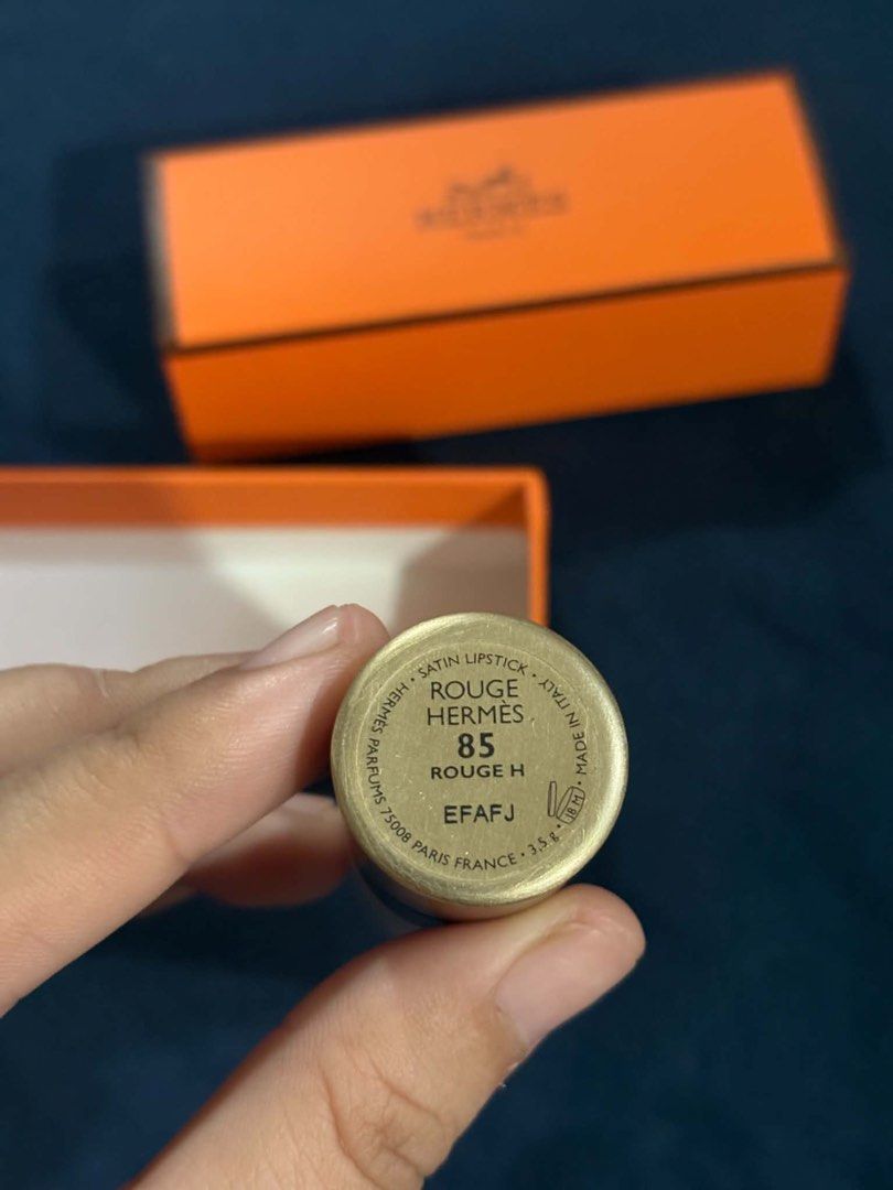 Hermes Rouge Lipstick (Category: Makeup) located in Makati City. Submitted by florabells (Listing ID 1460927846, Image 2). Description: - Authentic Hermes lipstick - Deep red shade - Comes with original orange box and inner packaging - Black lipstick case with gold accents - Perfect for adding a pop of color.