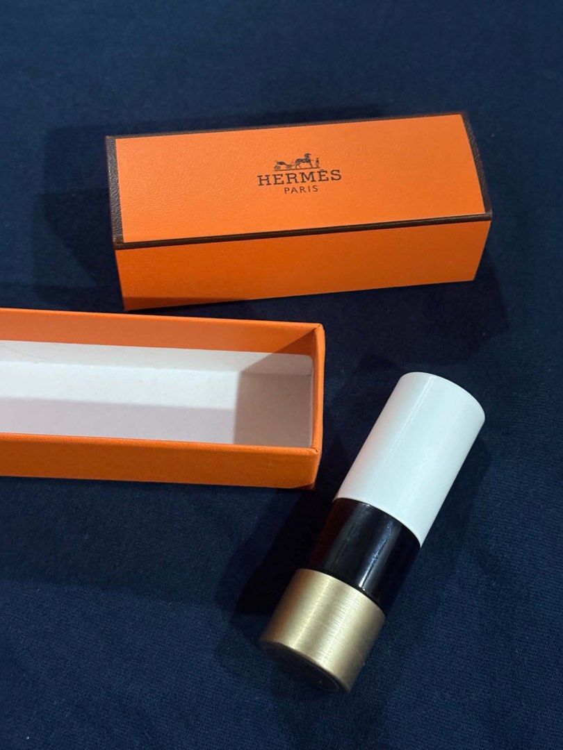 Hermes Rouge Lipstick (Category: Makeup) located in Makati City. Submitted by florabells (Listing ID 1460927846, Image 3). Description: - Authentic Hermes lipstick - Deep red shade - Comes with original orange box and inner packaging - Black lipstick case with gold accents - Perfect for adding a pop of color.