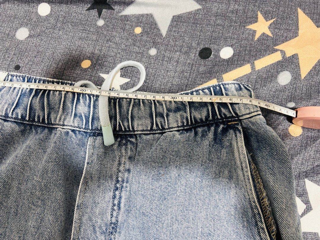 H&M Loose fit pants (Category: Jeans) located in Cavite. Submitted by kyliekaye (Listing ID 1461011484, Image 3). Description: - Brand: H&M - Style: Light wash denim jeans - Fit: Loose fit - Features: Elasticated waistband with drawstring, front and back pockets - Origin: Made in Bangladesh - Measurements (laid flat): Waist approx. 14 inches, Inseam approx. 27 inches - Unisex for men and women.