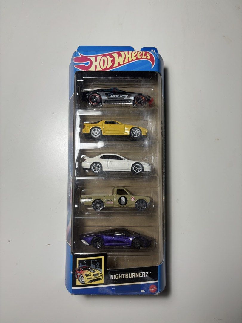 Hot Wheels Nightburnerz 5-Pack 2022 HFV93 (Category: Vehicle & Diecast Models) located in Agdangan. Submitted by omomsyj (Listing ID 1461054387, Image 1). Description: Selling my Hot Wheels Nightburnerz 5-Pack (2022) featuring: • Alpha Pursuit • ’89 Mazda Savanna RX-7 FC3S • ’98 Honda Prelude • Datsun 620 • McLaren Speedtail Condition: Sealed/Never Opened. The original packaging is intact. The card has minor fading/color changes and light signs o