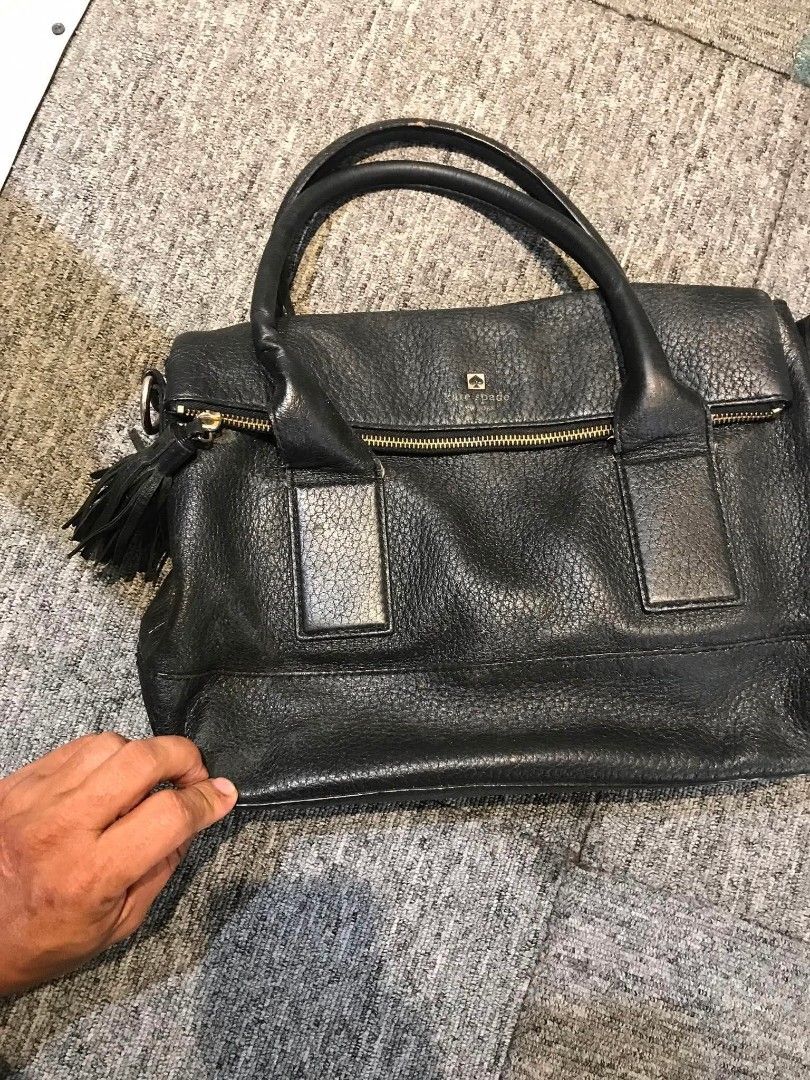 Kate Spade Black Leather Satchel Handbag (Category: Luxury Bags & Wallets) located in Manila. Submitted by youngstorm-c604 (Listing ID 1461006259, Image 2). Description: - Brand: Kate Spade - Material: Black pebbled leather - Hardware: Gold - Closure: Zip - Details: Side tassel, black and white striped lining - Features: Detachable shoulder strap - Condition: Spacious, perfect for essentials.