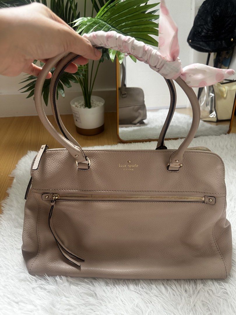 Kate Spade Pebble Leather Satchel Bag (Category: Luxury Bags & Wallets) located in Makati City. Submitted by findsbysai (Listing ID 1460953174, Image 2). Description: - Light pink Kate Spade satchel bag - Made of durable pebble leather - Interior features a fun striped pattern and multiple compartments - Elegant gold-tone hardware - Comes with a cute floral scarf tied to the handle - Spacious enough for all your daily essentials - Ideal for every