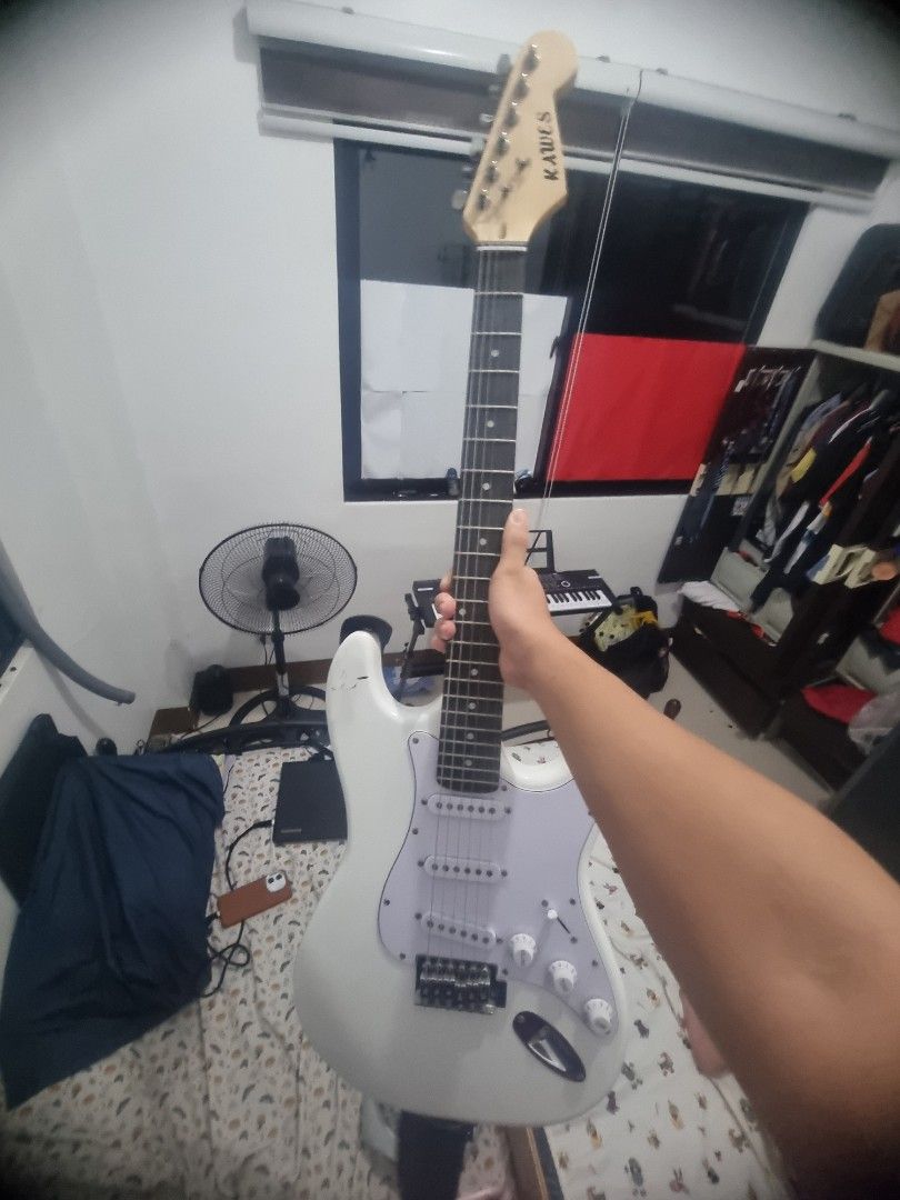 KAWES White Electric Guitar (Category: Musical Instruments) located in Kalibo. Submitted by zealmoon_00102e (Listing ID 1461080560, Image 2). Description: - White electric guitar with a Stratocaster-style body. - Comes with a black guitar strap. - Ready to play right out of the box. - Ideal for beginner guitarists or as a Kawes E Guitar ₱3000 Fresh Strings Ernie Ball 2723 Cobalt Super Slinky 9-42 Freebies: Cable Capo Guitar Strap 1 year palang RF