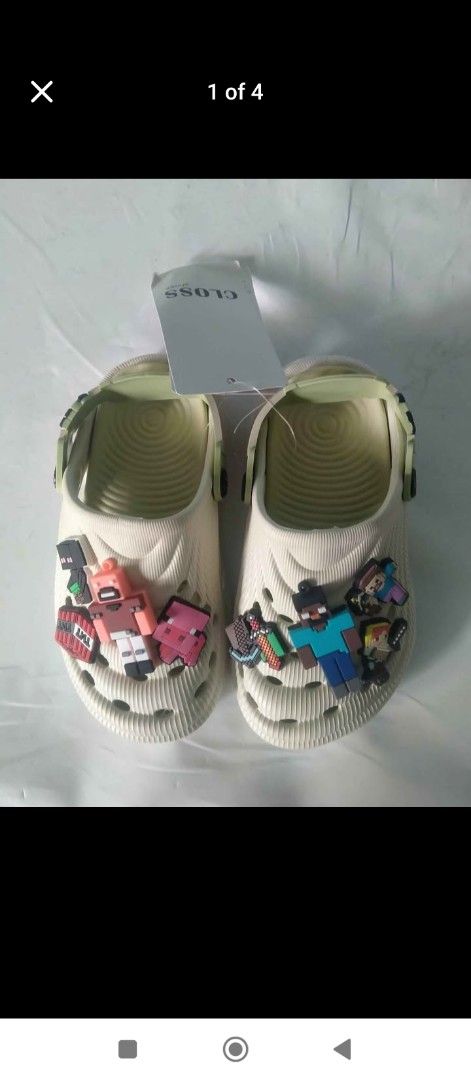 Kids' Sandals with Minecraft Charms (Category: Babies & Kids Fashion) located in Cavite. Submitted by jakeped86911 (Listing ID 1461054861, Image 1). Description: - Cute light-colored sandals for kids - Features fun Minecraft-themed charms - Easy slip-on and off design - Textured grip soles for safety - Ideal for casual wear - Comes in original packaging.