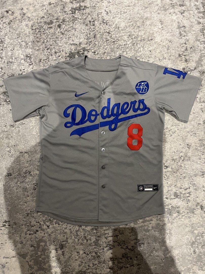 Kobe Bryant LA Dodgers Baseball Jersey #8 (Category: Tshirts & Polo Shirts ) located in Quezon City. Submitted by purplepproni (Listing ID 1461006394, Image 1). Description: - Grey Nike baseball jersey - Los Angeles Dodgers design - Features Dodgers script logo on chest - Number 8 on the front - LA Dodgers logo on the sleeve - Nike swoosh detail - Button-up front - Perfect for Dodgers fans.