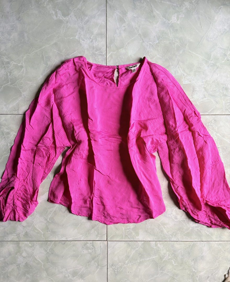 Koton Pink Long Sleeve Blouse (Category: Blouses) located in General Santos City (Dadiangas). Submitted by ssssshhhhhhhhh (Listing ID 1460973398, Image 1). Description: - Vibrant bright pink Koton blouse - Features long balloon sleeves with elasticated cuffs - Elegant keyhole detail at the neckline - Fabric has a subtle vertical stripe texture - Perfect for dressing up or down, offering great versatility.