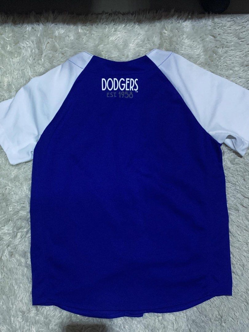 LA Dodgers MLB Baseball Jersey Blue White (Category: Tshirts & Polo Shirts ) located in General Santos City (Dadiangas). Submitted by thrifty_gsc (Listing ID 1461022844, Image 2). Description: - Authentic LA Dodgers baseball jersey - Classic blue with white sleeves and trim - Full button front for a traditional look - Features 'Dodgers' and 'LA' logo on the front - 'Dodgers Est. 1958' embroidered on the back - A must-have for any dedicated Dodger