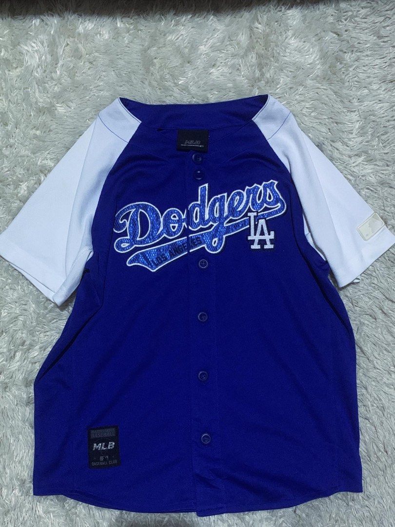 LA Dodgers MLB Baseball Jersey Blue White (Category: Tshirts & Polo Shirts ) located in General Santos City (Dadiangas). Submitted by thrifty_gsc (Listing ID 1461022844, Image 1). Description: - Authentic LA Dodgers baseball jersey - Classic blue with white sleeves and trim - Full button front for a traditional look - Features 'Dodgers' and 'LA' logo on the front - 'Dodgers Est. 1958' embroidered on the back - A must-have for any dedicated Dodger