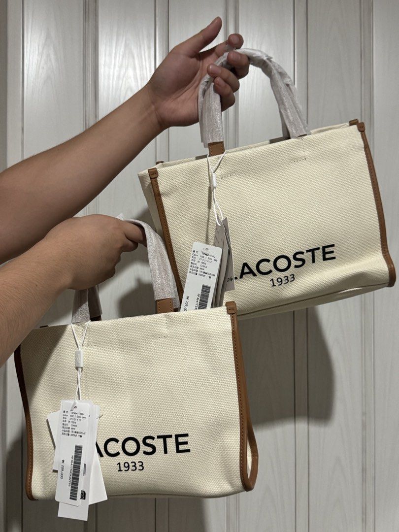Lacoste 1933 Canvas Tote Bag (Category: Tote Bags) located in Bulacan. Submitted by jodayyyyyy (Listing ID 1461094346, Image 2). Description: - Classic Lacoste tote bag - Color: Cream canvas with brown trim - Features iconic Lacoste 1933 logo on the front - Includes top handles and a detachable shoulder strap - Ideal for everyday use - Comes with original tags & DUSTBAG.
