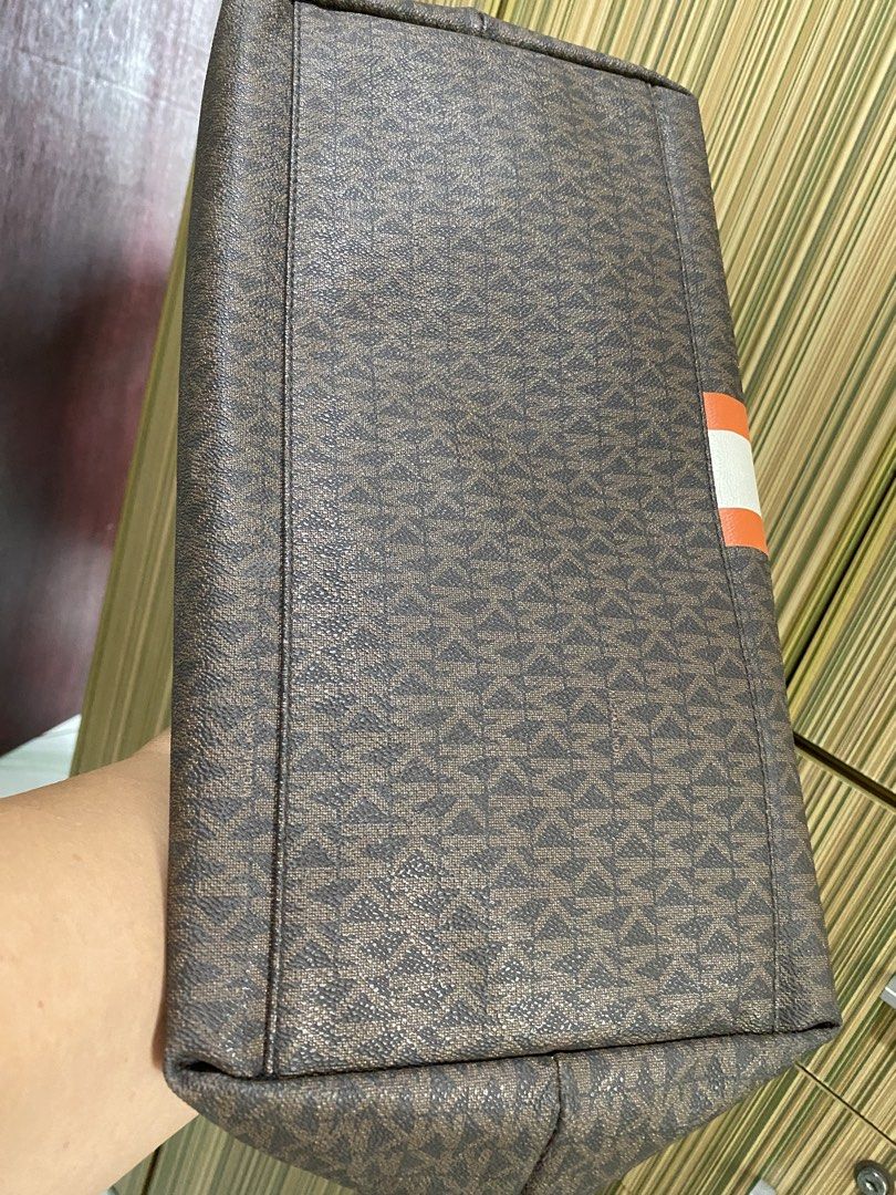 Large Michael Kors Monogram Tote Bag with Orange Stripe (Category: Luxury Bags & Wallets) located in Taguig. Submitted by sandzclick (Listing ID 1460977943, Image 3). Description: - Authentic Michael Kors tote bag - Classic MK monogram print - Bold orange and white stripe detail on front - Genuine leather trim and handles - Spacious interior with zip closure - Ideal for everyday use or travel.