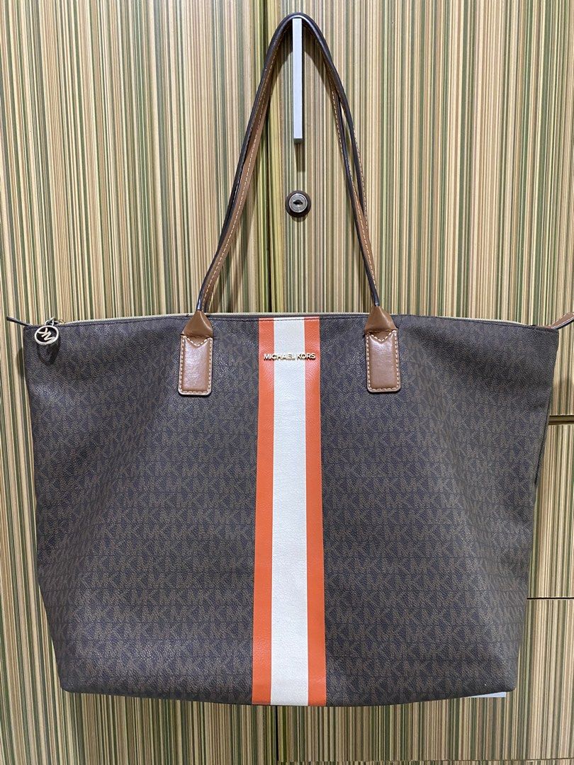 Large Michael Kors Monogram Tote Bag with Orange Stripe (Category: Luxury Bags & Wallets) located in Taguig. Submitted by sandzclick (Listing ID 1460977943, Image 1). Description: - Authentic Michael Kors tote bag - Classic MK monogram print - Bold orange and white stripe detail on front - Genuine leather trim and handles - Spacious interior with zip closure - Ideal for everyday use or travel.