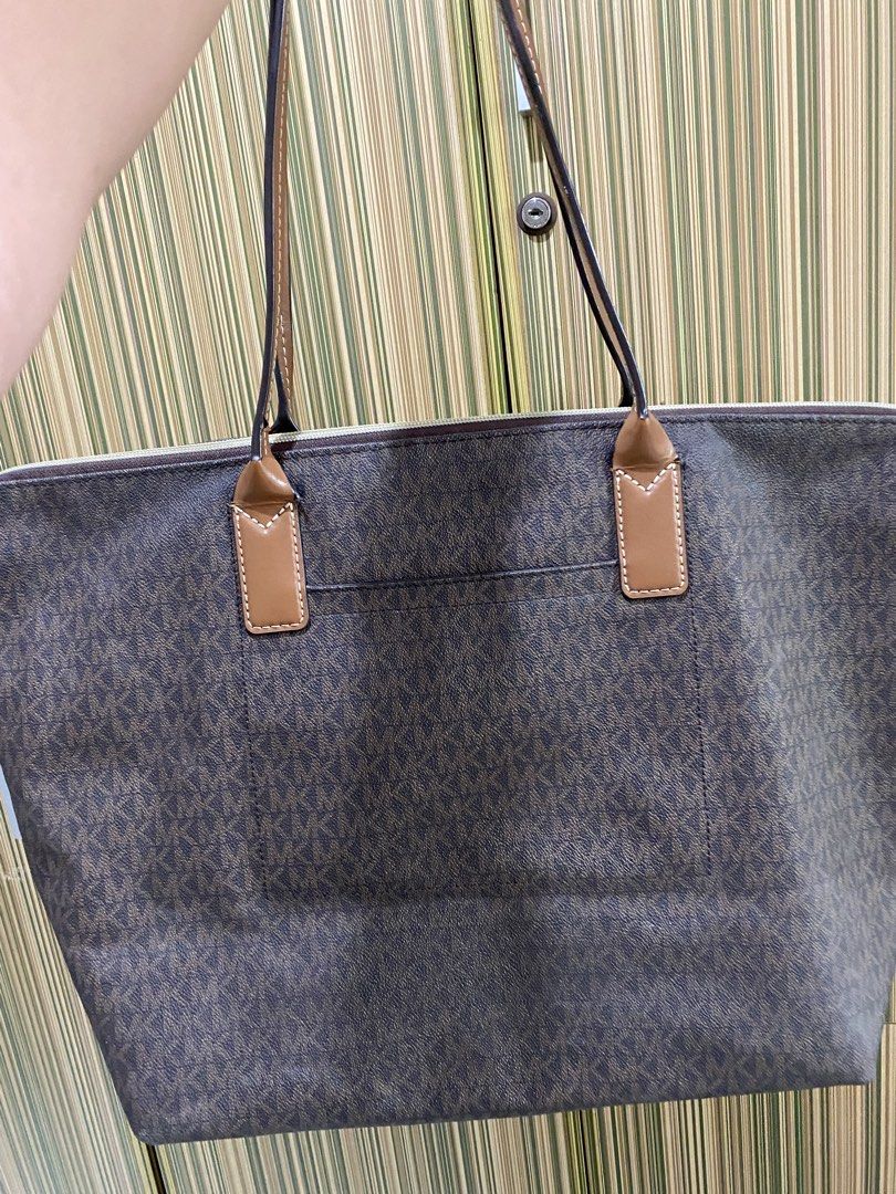 Large Michael Kors Monogram Tote Bag with Orange Stripe (Category: Luxury Bags & Wallets) located in Taguig. Submitted by sandzclick (Listing ID 1460977943, Image 2). Description: - Authentic Michael Kors tote bag - Classic MK monogram print - Bold orange and white stripe detail on front - Genuine leather trim and handles - Spacious interior with zip closure - Ideal for everyday use or travel.