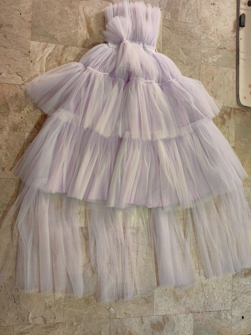 lavender tiered tulle gown (Category: Evening dresses & gowns) located in Calamba. Submitted by princesspauliney. (Listing ID 1461037799, Image 1). Description: Tube lavender tiered tulle gown. This style features a structured, pleated or gathered sweetheart bodice paired with a voluminous, multi-layered dramatic tulle skirt. It is a popular design choice for formal events, prom nights, and photoshoots. 50inches bust to foot Best fit 5'2 to 5'4.