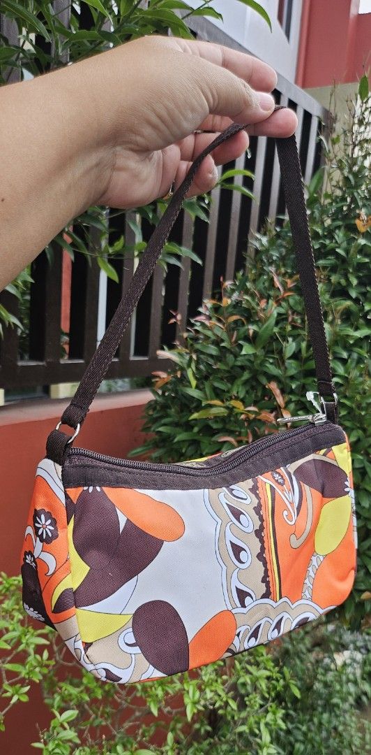 LeSportsac Shoulder Bag - Psychedelic Orange Print (Category: Shoulder Bags) located in Cavite. Submitted by sunghanphil_31 (Listing ID 1461088462, Image 3). Description: - Cute LeSportsac shoulder bag - Fun, colorful psychedelic print (orange, brown, white) - Zipper closure - Dark brown strap - Compact size, great for everyday use - Adds a pop of color to any outfit.