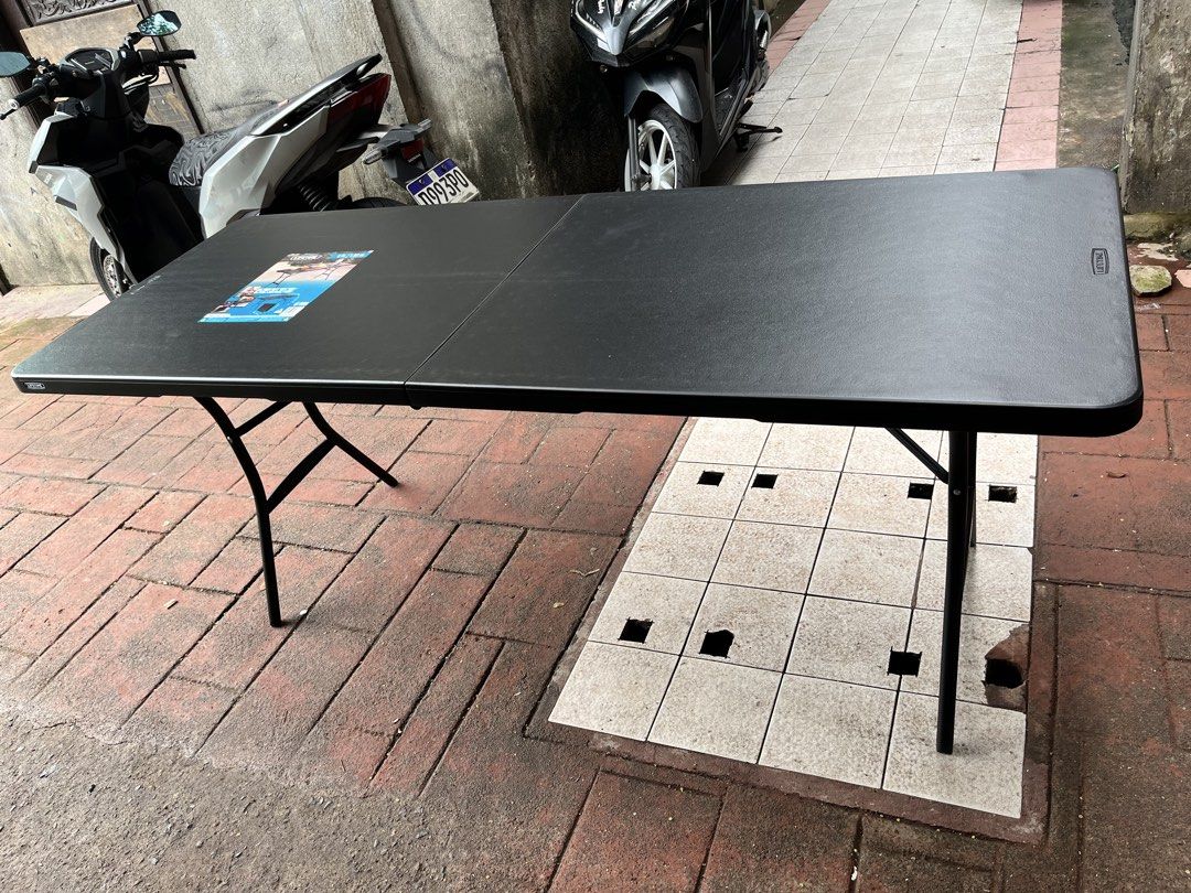 Lifetime 6-Foot Folding Table (Category: Tables & Sets) located in Marikina City. Submitted by loraineroy1016 (Listing ID 1460963221, Image 3). Description: - Lifetime 6-foot folding table - Color: Black - Folds in half for convenient storage and transport - Durable plastic top - Legs fold out securely - Ideal for parties, events, or as extra workspace - Ready for its next use.