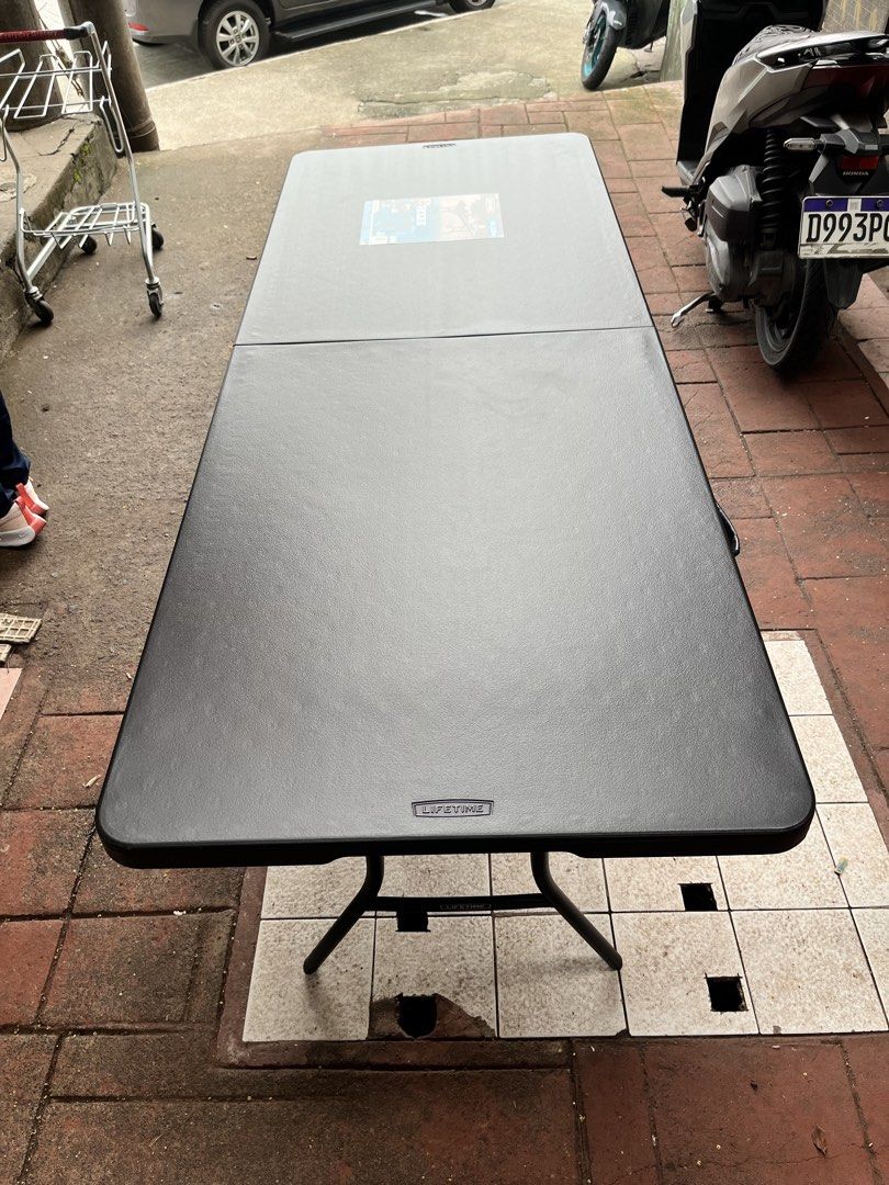 Lifetime 6-Foot Folding Table (Category: Tables & Sets) located in Marikina City. Submitted by loraineroy1016 (Listing ID 1460963221, Image 2). Description: - Lifetime 6-foot folding table - Color: Black - Folds in half for convenient storage and transport - Durable plastic top - Legs fold out securely - Ideal for parties, events, or as extra workspace - Ready for its next use.