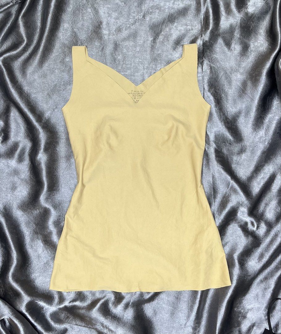 Light Yellow V-Neck Tank Top (Category: Sleeveless) located in Cavite. Submitted by bellewii (Listing ID 1461070557, Image 1). Description: - Basic light yellow tank top - Flattering V-neck design - Sleeveless style - Stretchy material for a comfortable fit - Perfect for layering or wearing on its own - A versatile addition to any wardrobe.