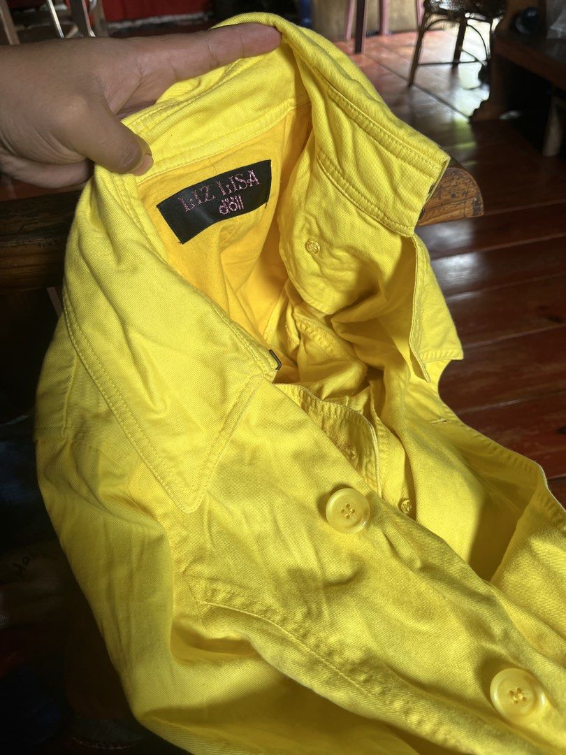 LIZ LISA Doll Yellow Button-Up Jacket Size M (Category: Coats, Jackets and Outerwear) located in Tabuk. Submitted by collectors_thrift_shop (Listing ID 1461017080, Image 2). Description: - Cute yellow jacket from LIZ LISA Doll - Features button-up front and collar - Size: Medium (M) - Material: 100% Cotton - Ideal for casual wear.