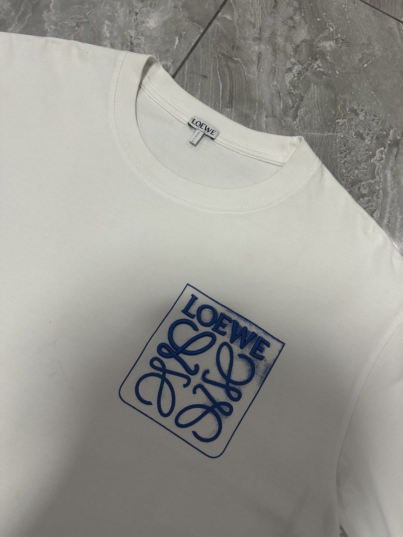 LOEWE ANAGRAM FAKE POCKET TEE (Category: Luxury Apparel) located in Manila. Submitted by 2ndstitch (Listing ID 1461004226, Image 2). Description: LOEWE Anagram Fake Pocket T-shirt White/Blue Issue/s: NONE ( need wash only ) Size: Medium ( Large Fit ) Dimes: 22x28 Overall condition: 9.5/10.