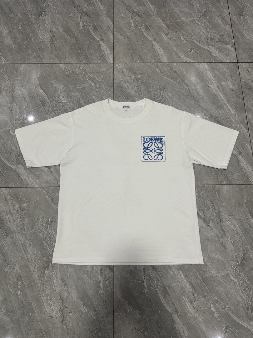 LOEWE ANAGRAM FAKE POCKET TEE (Category: Luxury Apparel) located in Manila. Submitted by 2ndstitch (Listing ID 1461004226, Image 1). Description: LOEWE Anagram Fake Pocket T-shirt White/Blue Issue/s: NONE ( need wash only ) Size: Medium ( Large Fit ) Dimes: 22x28 Overall condition: 9.5/10.