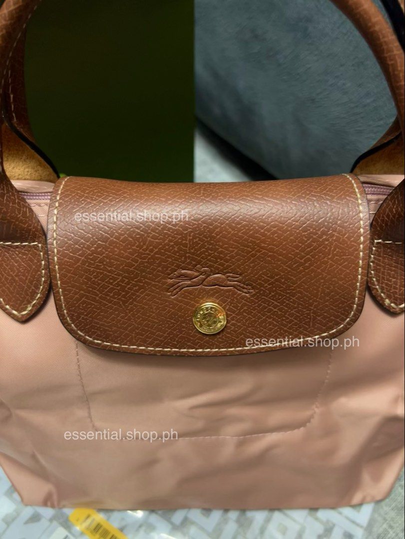 Longchamp Le Pliage Original Small Short Handle Bag Pink Tea (Category: Luxury Bags & Wallets) located in Manila. Submitted by essential.shop.ph (Listing ID 1461043396, Image 2). Description: PREORDER. 7-10 days ETA. ☺️ Longchamp Le Pliage Original Small Short Handle Pink Tea ***Actual color difficult to capture. Changes due to lighting. Includes care card, LGP zip lock pouch and paper bag. Dimensions 9.1 inches (L - measured at the base of the b
