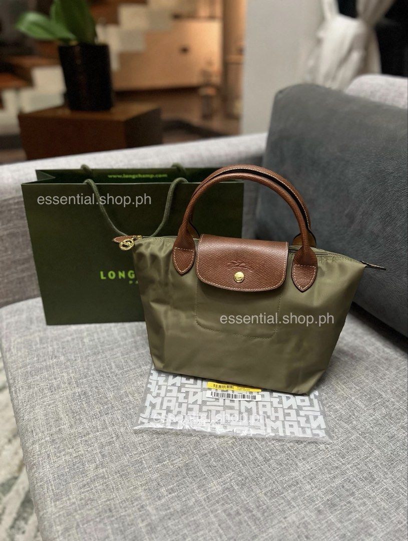 Longchamp Le Pliage Original Small Short Handle Olive (Category: Tote Bags) located in Manila. Submitted by essential.shop.ph (Listing ID 1461044046, Image 1). Description: PREORDER. 7-10 days ETA. ☺️ Longchamp Le Pliage Original Small Short Handle Olive ***Actual color difficult to capture. Changes due to lighting. Includes care card, LGP zip lock pouch and paper bag. Dimensions 9.1 inches (L - measured at the base of the bag) x 8.5 inches (H) x