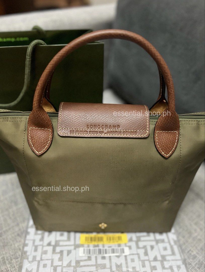 Longchamp Le Pliage Original Small Short Handle Olive (Category: Tote Bags) located in Manila. Submitted by essential.shop.ph (Listing ID 1461044046, Image 2). Description: PREORDER. 7-10 days ETA. ☺️ Longchamp Le Pliage Original Small Short Handle Olive ***Actual color difficult to capture. Changes due to lighting. Includes care card, LGP zip lock pouch and paper bag. Dimensions 9.1 inches (L - measured at the base of the bag) x 8.5 inches (H) x