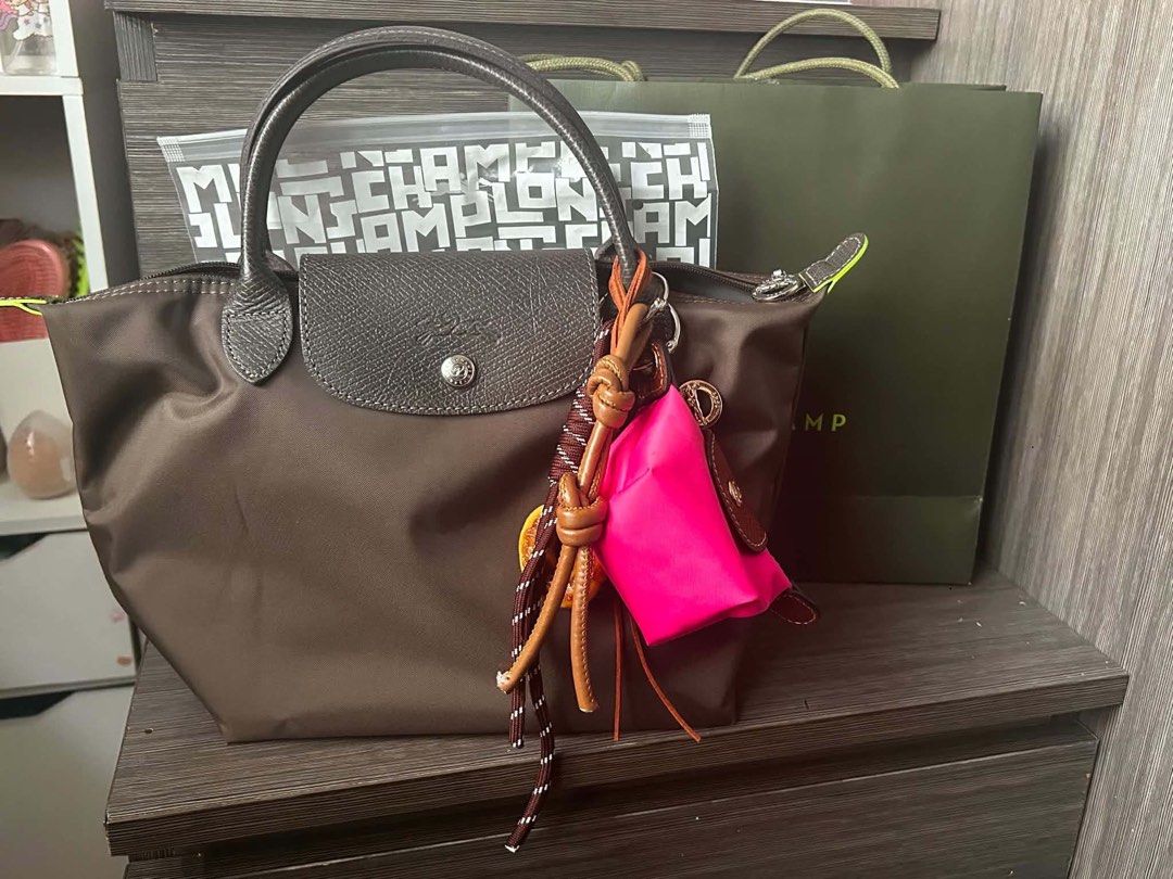 Longchamp Le Pliage Top Handle Bag (Category: Luxury Bags & Wallets) located in Marikina City. Submitted by cristinelinghon12 (Listing ID 1460996729, Image 1). Description: - Brand: Longchamp - Model: Le Pliage - Color: Brown - Size: Small - Condition: Good - Includes: Pink pouch and keychain - Ideal for: Everyday use WITH RECEIPT.