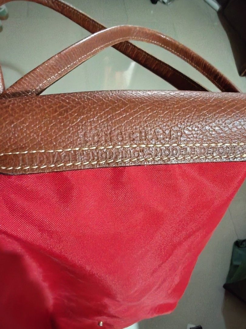 Longchamp Le Pliage Tote Bag Red Nylon Leather (Category: Luxury Bags & Wallets) located in Davao. Submitted by athenaprelovedph (Listing ID 1461007199, Image 2). Description: - Classic red Longchamp tote bag Large size long handle No tears, no holes - Ideal for carrying everyday essentials.