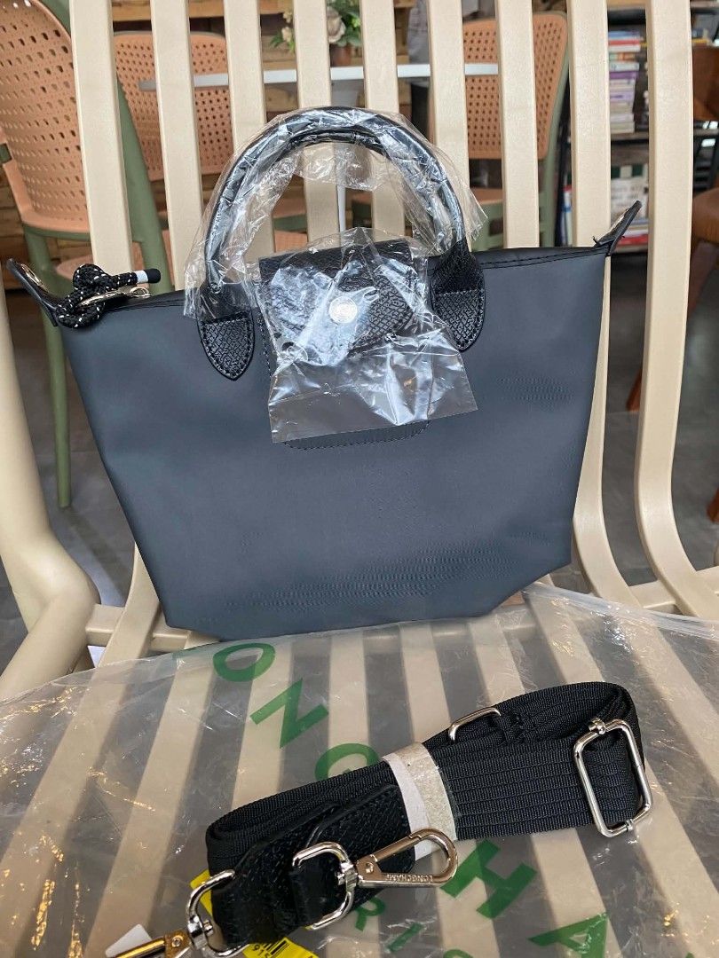 Longchamp Paris Le Pliage Top Handle Bag (Category: Luxury Bags & Wallets) located in Calamba. Submitted by loi.soliven (Listing ID 1460988674, Image 3). Description: - Vietnam - Brand new dark grey Longchamp Le Pliage bag - Top handle style with detachable shoulder strap - Ideal for everyday use or travel.